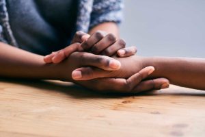 close up of one person holding another person's hands and asking can addicts recover