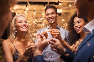 group of men and women toasting the New Year at a sober New Year's Eve party