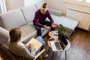 therapist discussing with male patient about the benefits of an intensive outpatient program