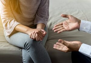 therapist explaining to patient why they would benefit from a PTSD treatment program