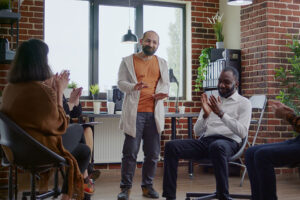 addiction treatment specialist leading a group therapy session as part of a polysubstance abuse treatment program