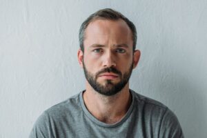 young man staring blankly straight ahead displaying common effects of fentanyl