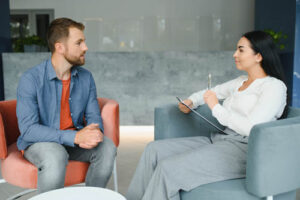 a person talks with a therapist in a process addiction treatment program