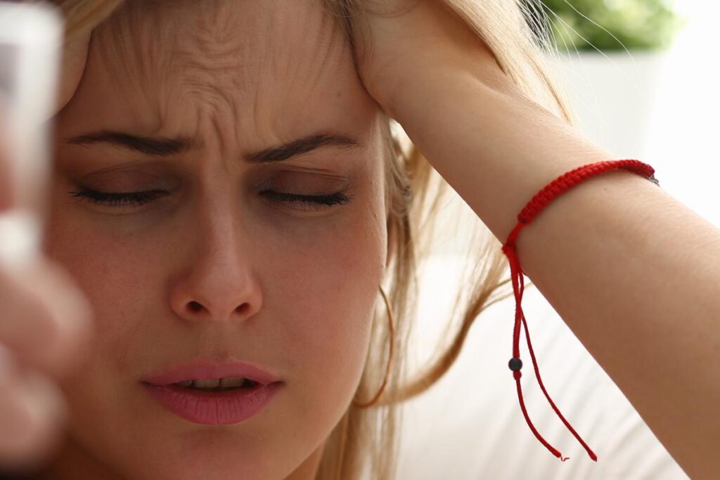 close up of woman who is angry and frustrated as she attempts to employ helpful tips for controlling anger