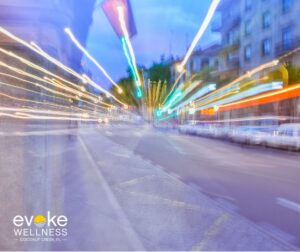 street and city lights go by in a haze