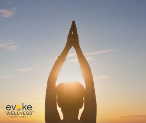 a woman practices yoga in the sun