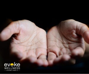 a person holds out their hands as if waiting to be given something