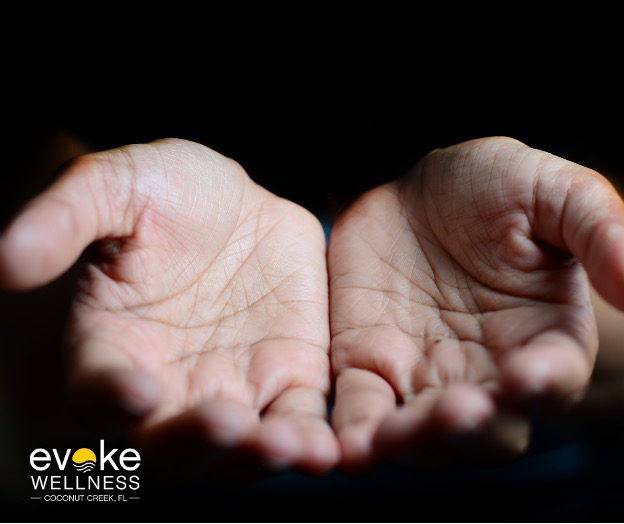 a person holds out their hands as if waiting to be given something